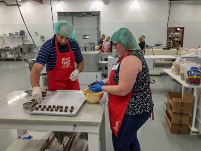 team rolling chocolate truffles