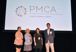 four people onstage with PMCA logo behind them