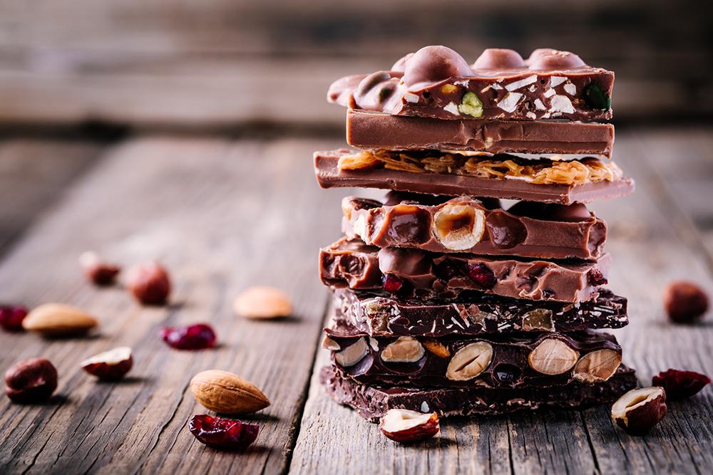 chocolate bars with nuts inclusions in a stack